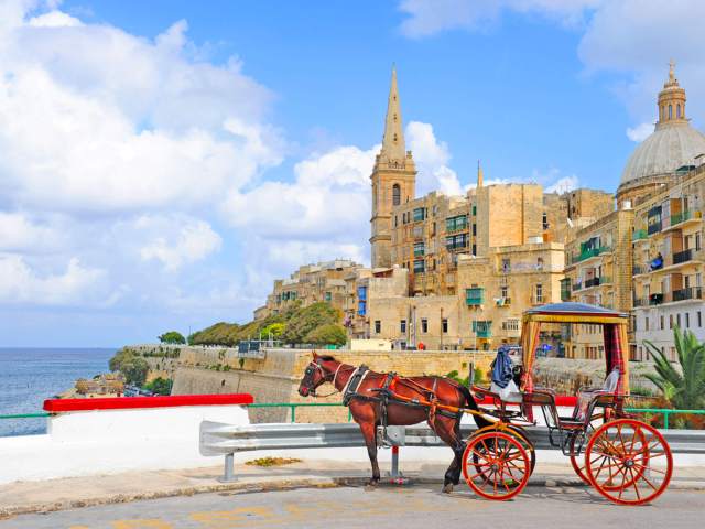 Horse-drawn carriage overlooking walled city of Valletta, Malta, and Mediterranean Sea