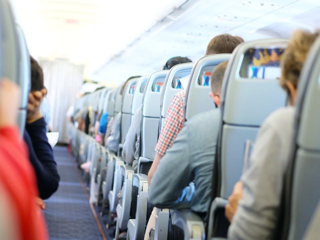 View inside airplane cabin facing toward front