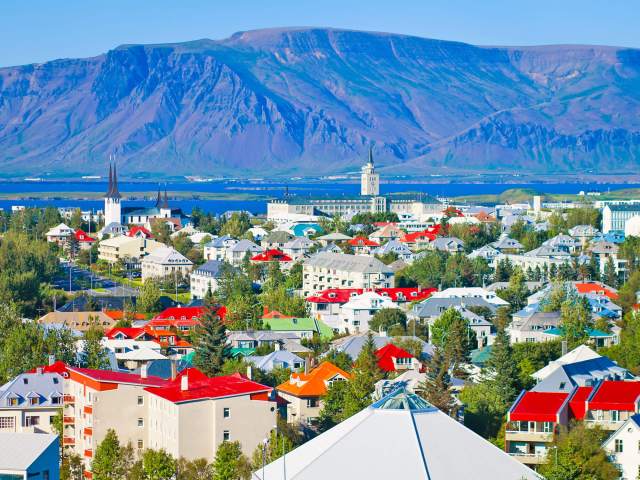 Aerial view of Reykjavik, Iceland, with mountains and bay in background