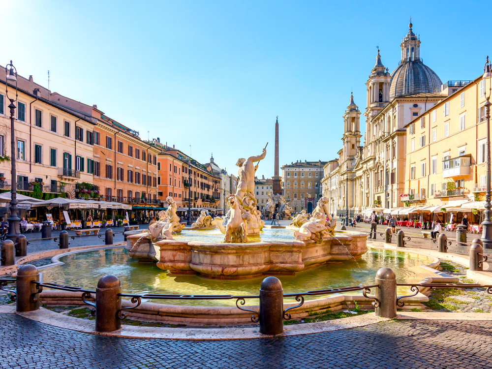 Neptune Fountain in Rome's Navona Square, surrounded by cafes