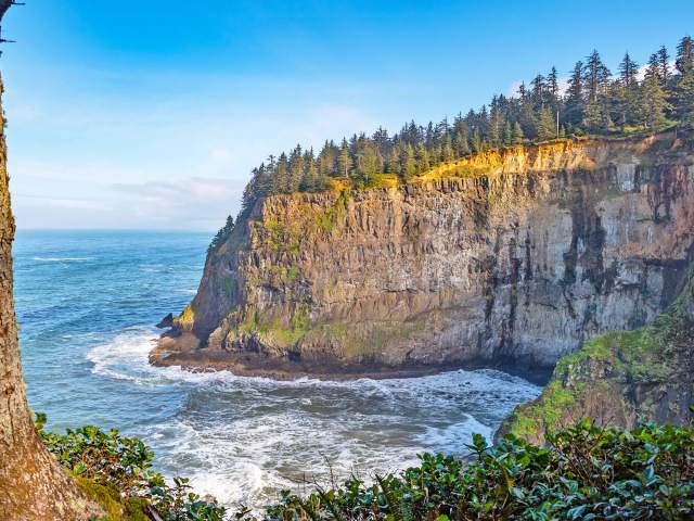 Tall coastal cliffs and bay off the coast of Tillamook, Oregon