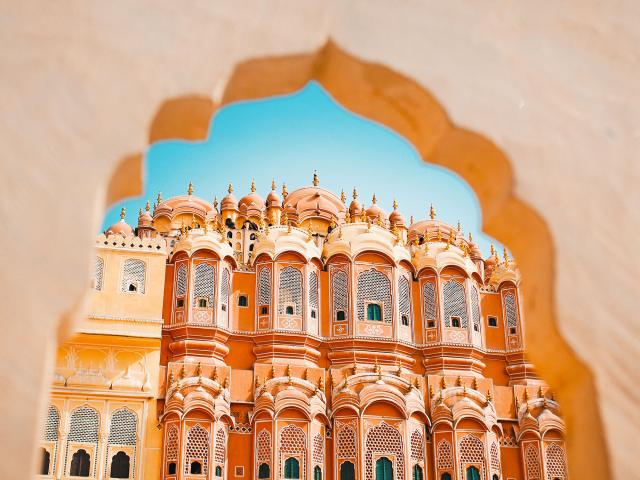 View of Hawa Mahal pink palace in Jaipur, India, through archway