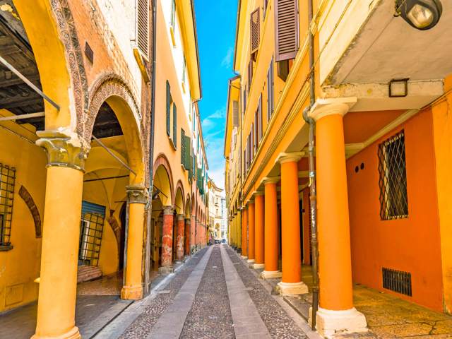 Narrow street lined with Porticoes of Bologna, Italy