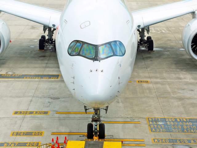 Head-on view of Airbus A350 aircraft parking at gate