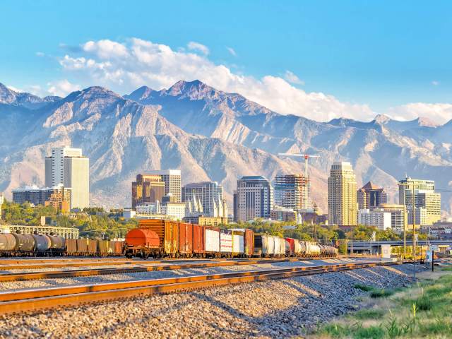 Railroad tracks with Salt Lake City, Utah, skyline and mountains in background