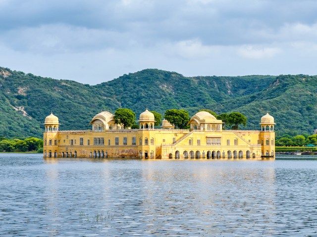Yellow-painted Jal Mahal palace floating in lake in Jaipur, India