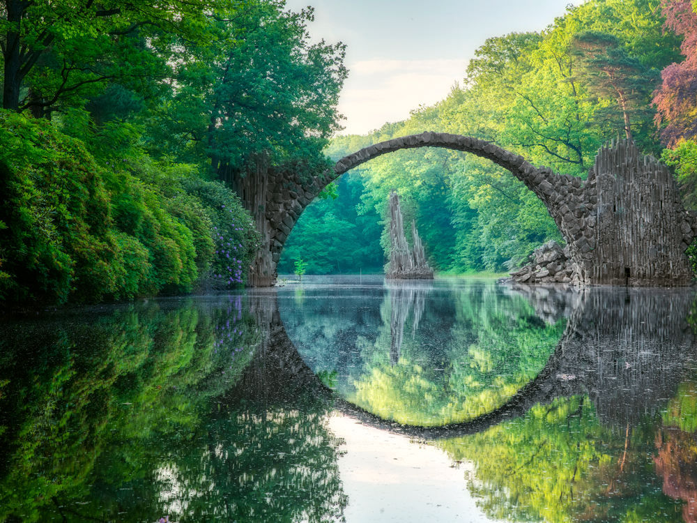 Rakotzbrücke bridge in Germany creating circular illusion with reflection on water