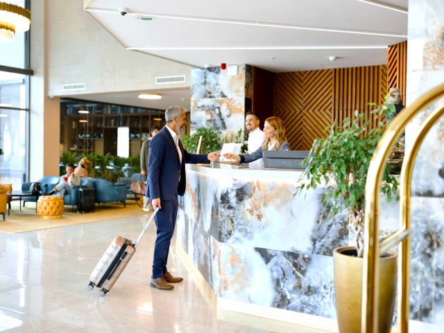 Traveler checking into hotel in lobby