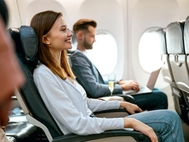 Smiling passenger seated on airplane