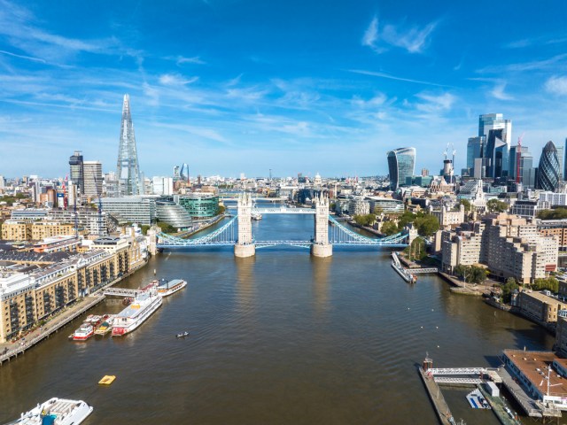Aerial view of Tower Bridge and London skyline beside River Thames