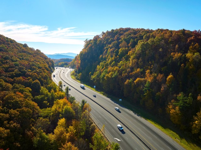 Aerial view of traffic on Interstate 40 through forested valley