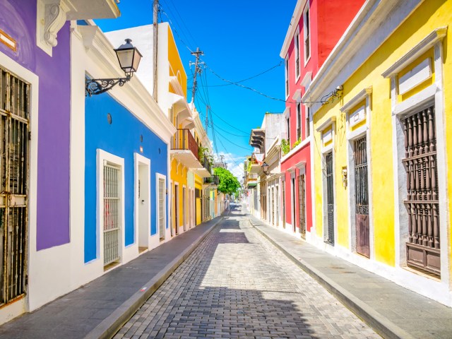 Narrow street lined with brightly painted homes in San Juan, Puerto Rico