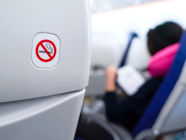 Close-up of no-smoking sign on airplane seatback