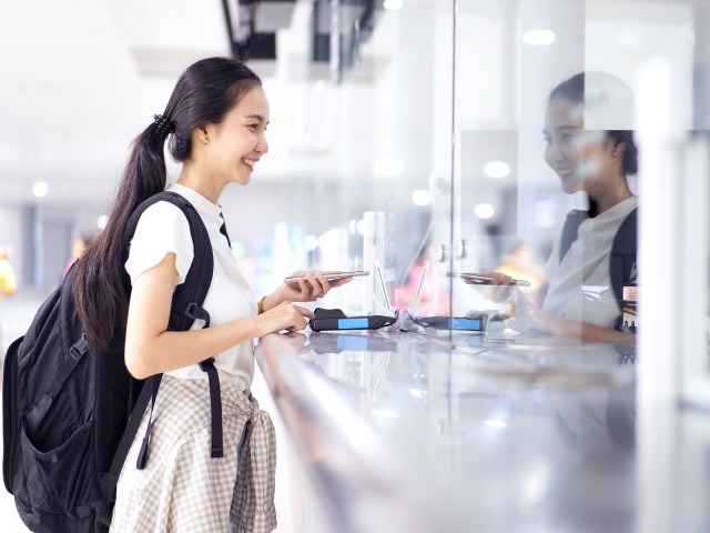 Traveler standing at airport check-in counter