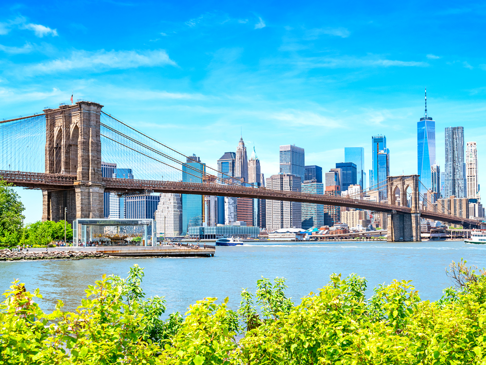 Brooklyn Bridge over East River with Manhattan skyline in background