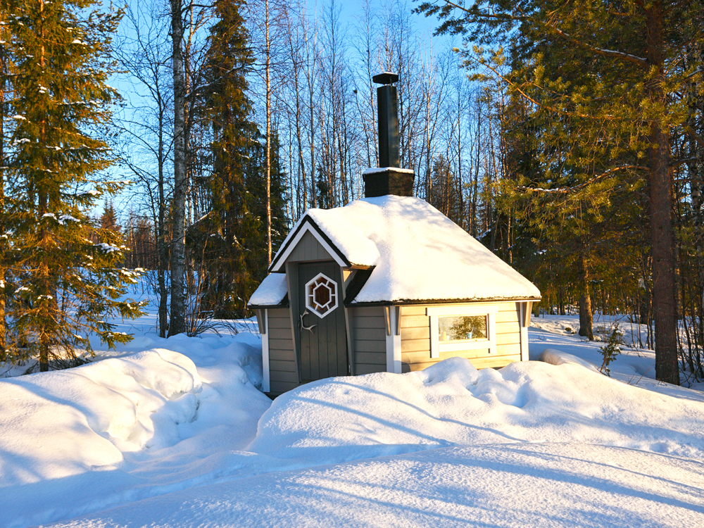 Snow-covered sauna house in Finland