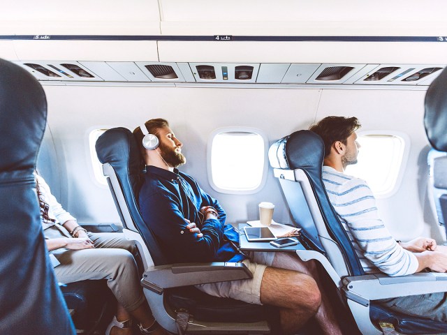 Passenger sleeping in airplane seat