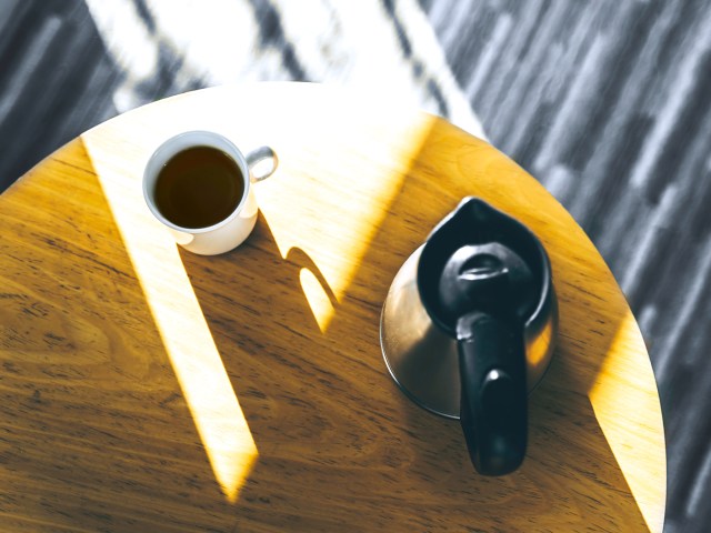 Pot of coffee and coffee mug on table