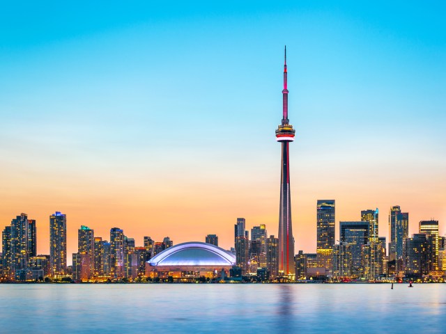 Skyline of Toronto, Canada, with CN Tower and Rogers Centre, seen at sunset