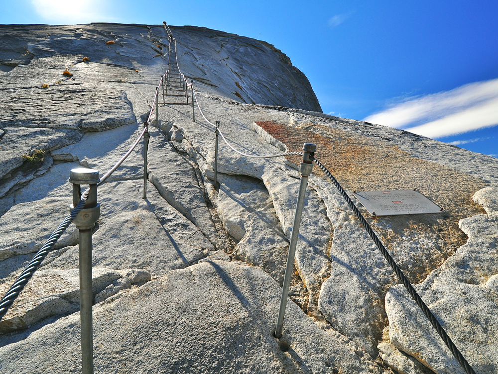 Cable ropes ascending Half Dome rock formation in Yosemite National Park, California