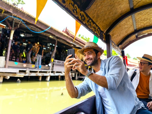 Traveler on boat tour taking photo