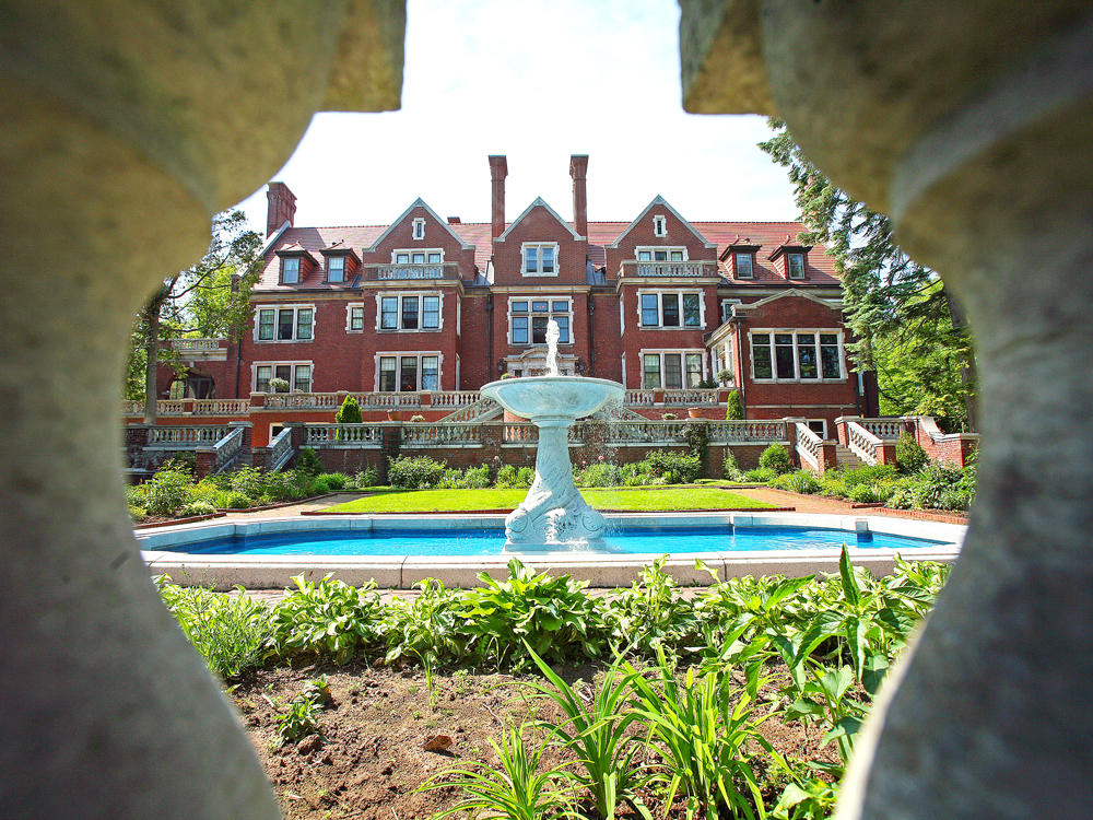 View between archway of fountain and grand facade of Glensheen estate in Duluth, Minnesota