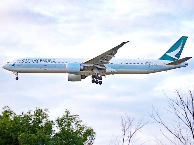 Cathay Pacific Boeing 777 on approach above treetops