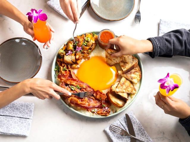 Diners enjoying the Ostrich Egg platter at the Pendry in San Diego, California