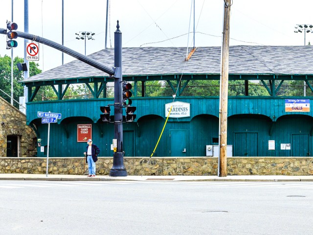 Person standing at intersection beside Cardines Field in Newport, Rhode Island