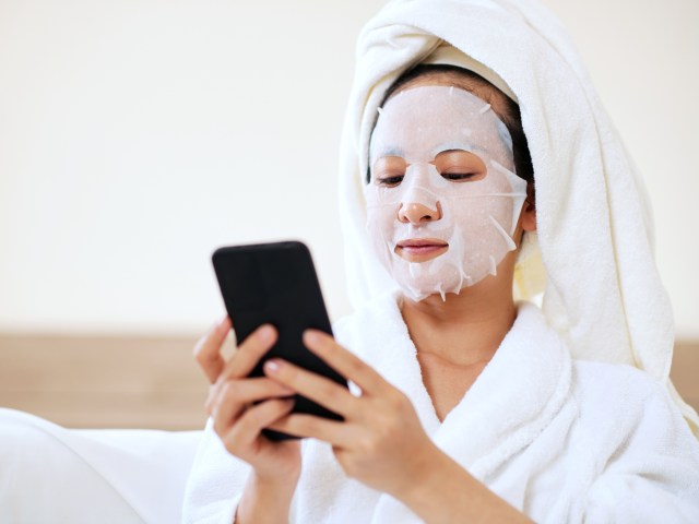 Person using phone while wearing face mask