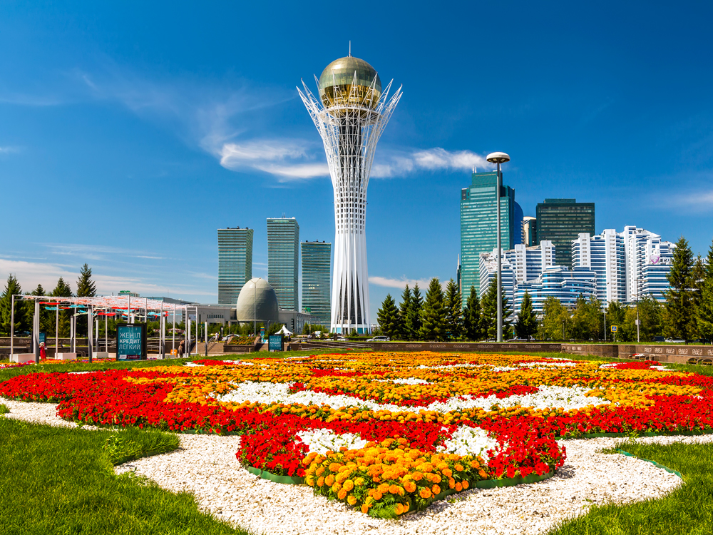 Flower-filled park with futuristic skyline of Astana, Kazakhstan, behind