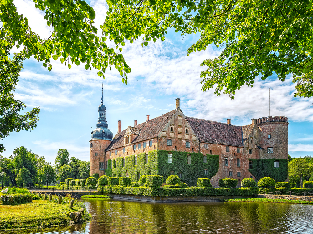 Castle surrounded by gardens and body of water in Kristianstad, Sweden
