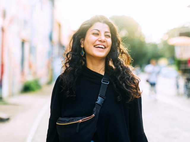 Smiling traveler wearing crossbody bag