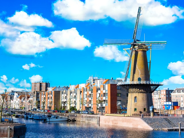 Large windmill and waterfront buildings in Rotterdam, The Netherlands