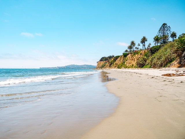 Wide, sandy Butterfly Beach lined with bluffs in Montecito, California