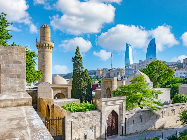 Mosque in Baku, Azerbaijan, with modern skyscrapers in distance