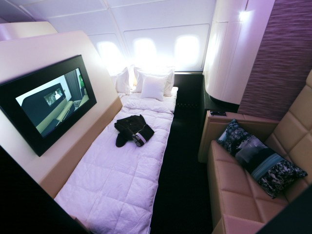 View of Etihad Airways First Class Apartment with bed, TV screen, and reclining seat