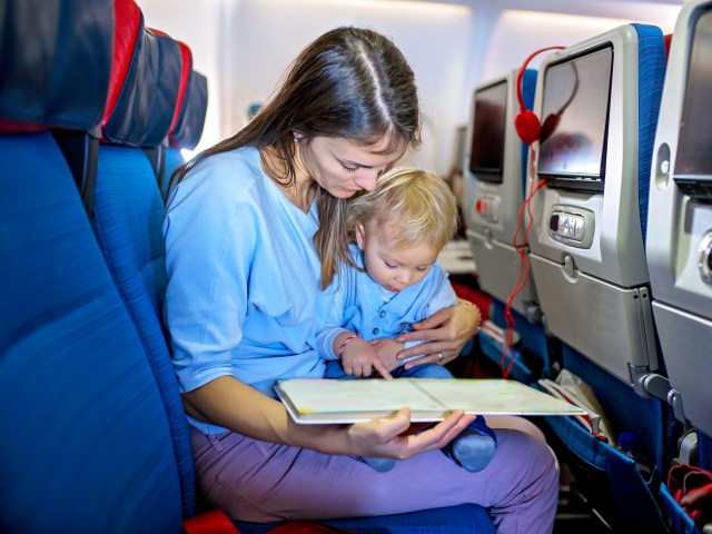 Mother reading to baby on airplane