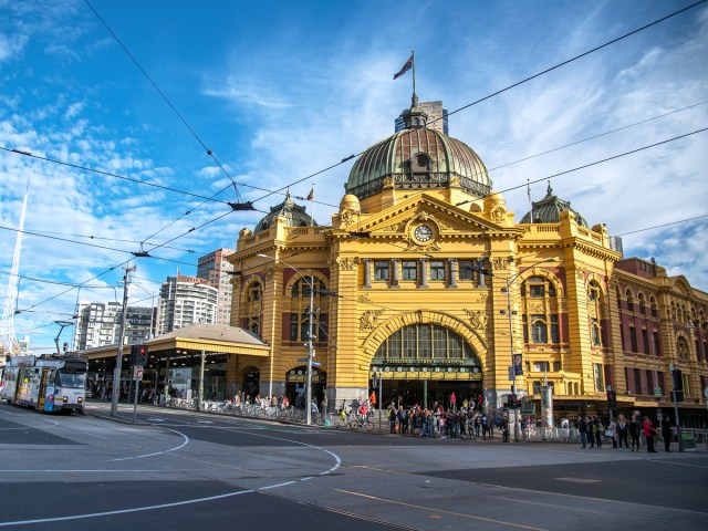 Grand yellow train station on street corner in Melbourne, Australia