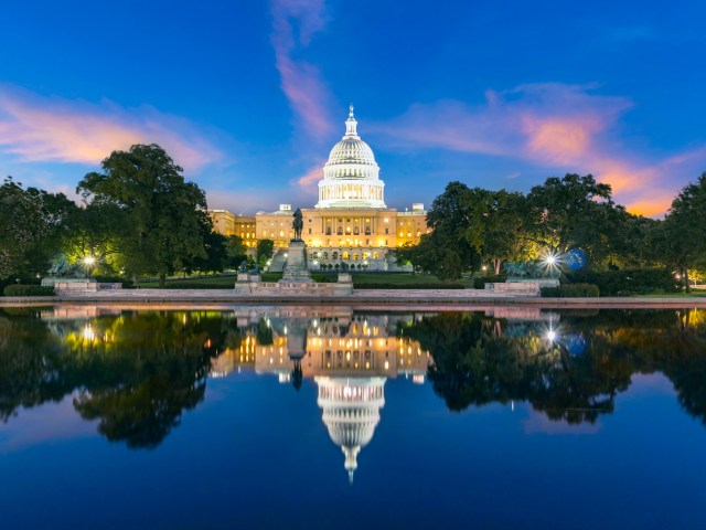 U.S. Capitol Building in Washington, D.C., with reflection on pool, seen at night