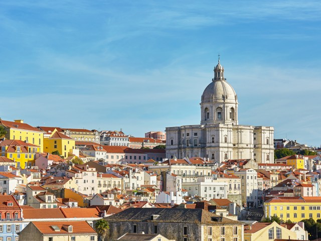 Domed church towering above red-roofed buildings in Lisbon, Portugal