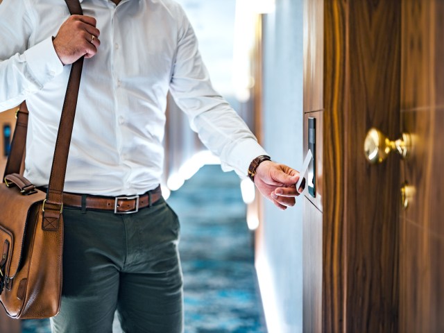 Hotel guest using key card to enter room