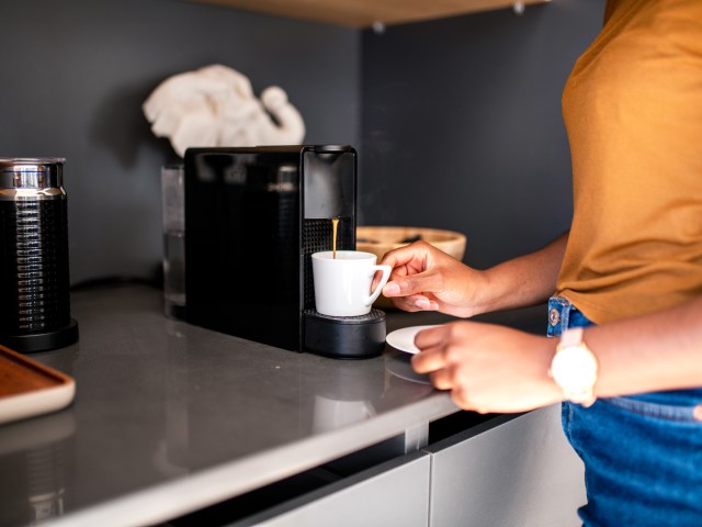 Hotel guest using coffee machine