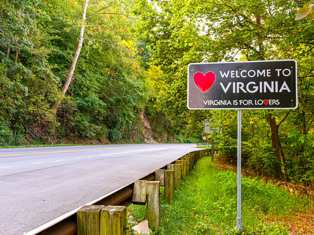 Highway welcome sign for Virginia with slogan "Virginia is for lovers"