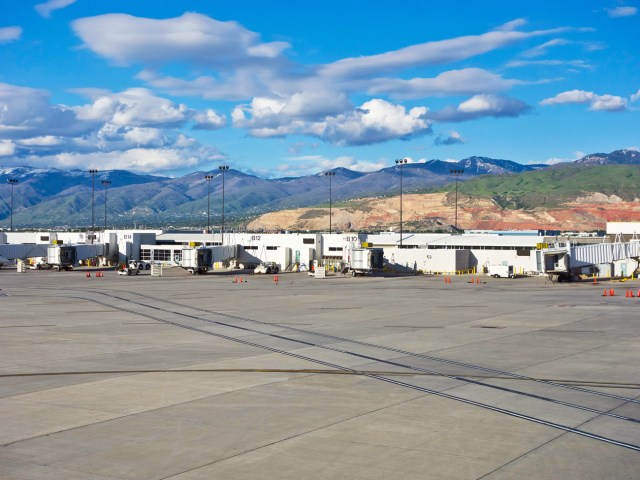 Empty terminal building with mountains in background at Salt Lake City International Airport