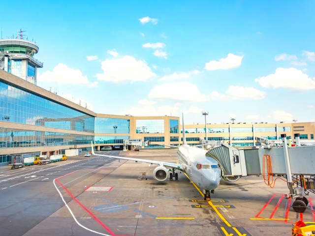 Aircraft parked at gate in airport terminal