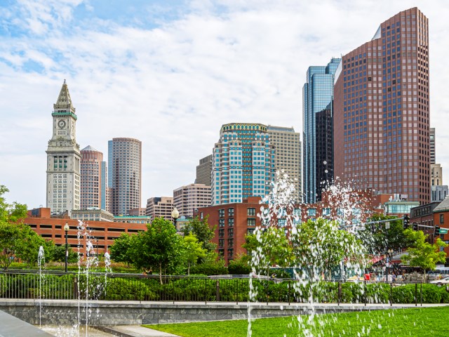 Custom House Bell Tower alongside other Boston skyscrapers, seen from across park