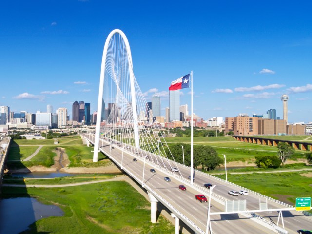 Aerial view of Margaret Hunt Hill Bridge with Dallas skyline in the distance