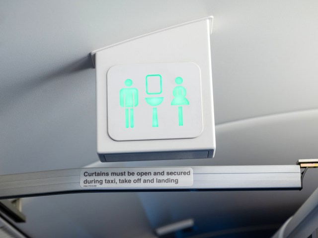 Illuminated lavatory sign on airplane