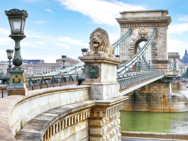 Lion statue guarding the Széchenyi Chain Bridge in Budapest, Hungary